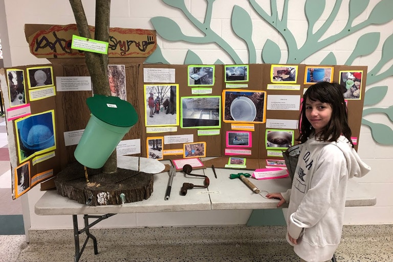 Girl with Maple Syrup Display at Foundation Christian School